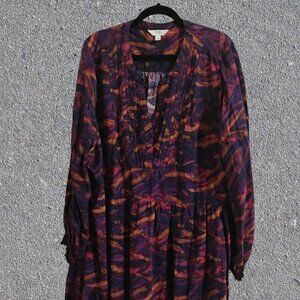 A Terra & Sky Women's Long Sleeve Pleated Tiered Dress With a Purple Brushstroke